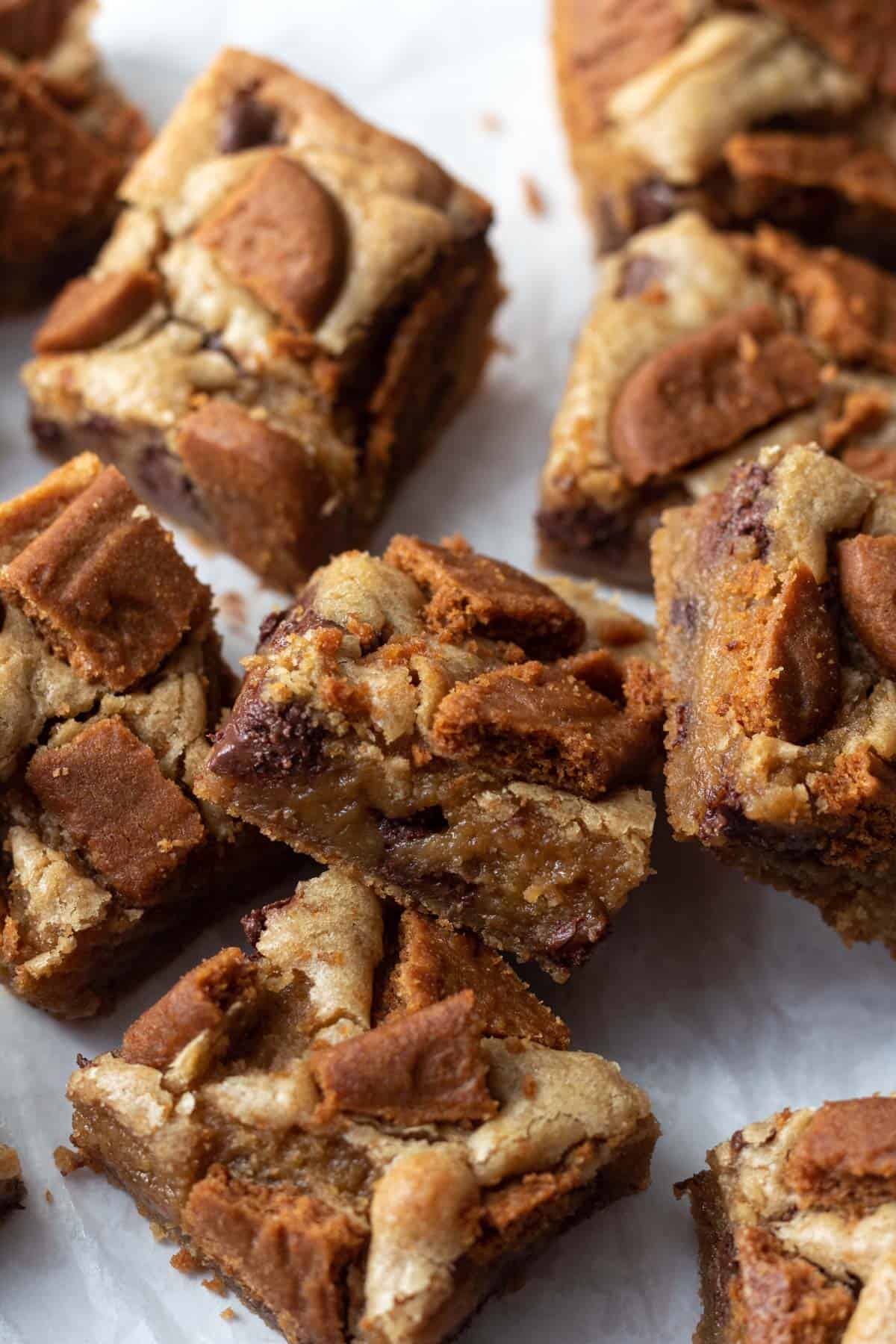 Biscoff blondie bar cut into squares with gooey center showing.