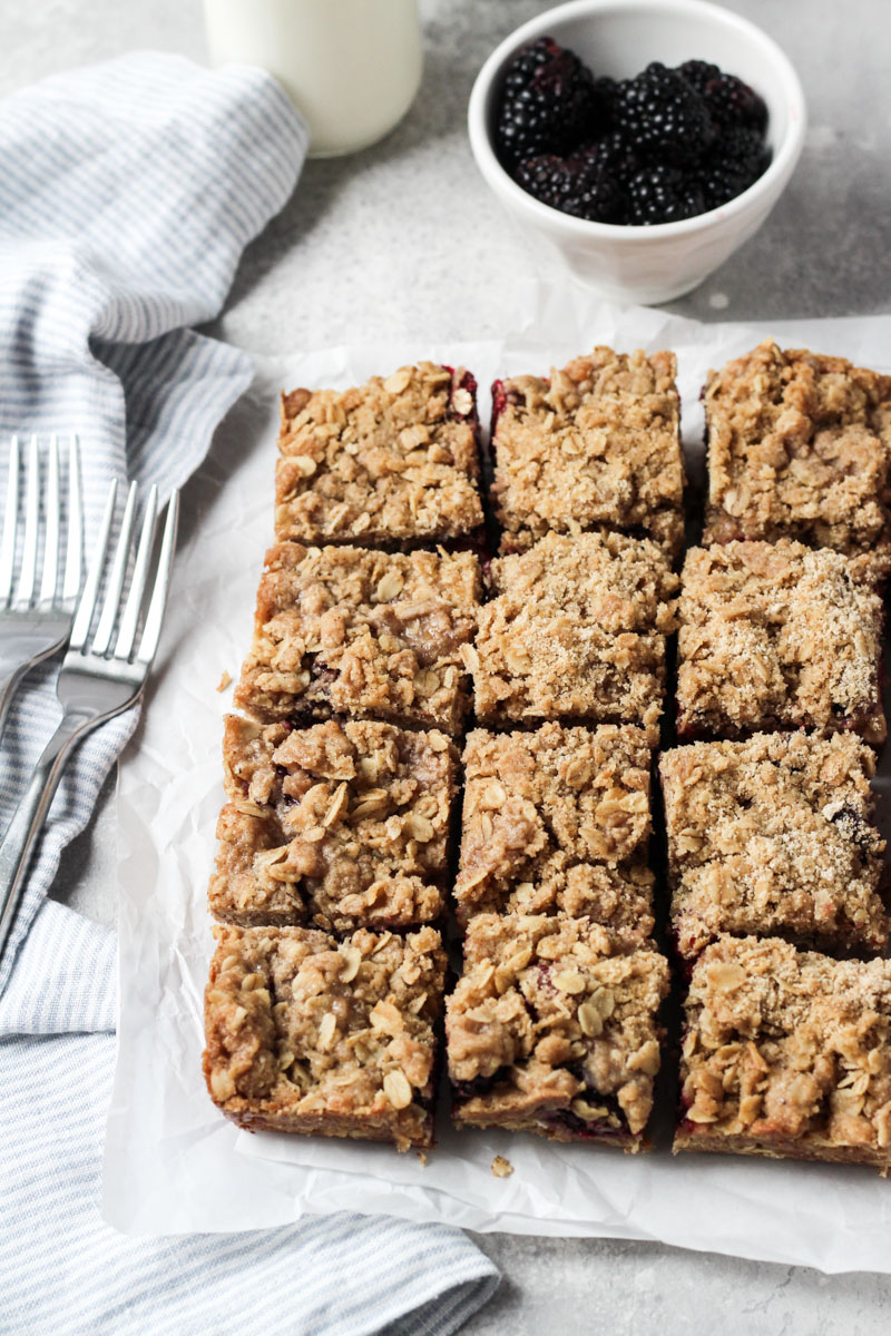 Blackberry bars with oat crumble topping cut into squares.