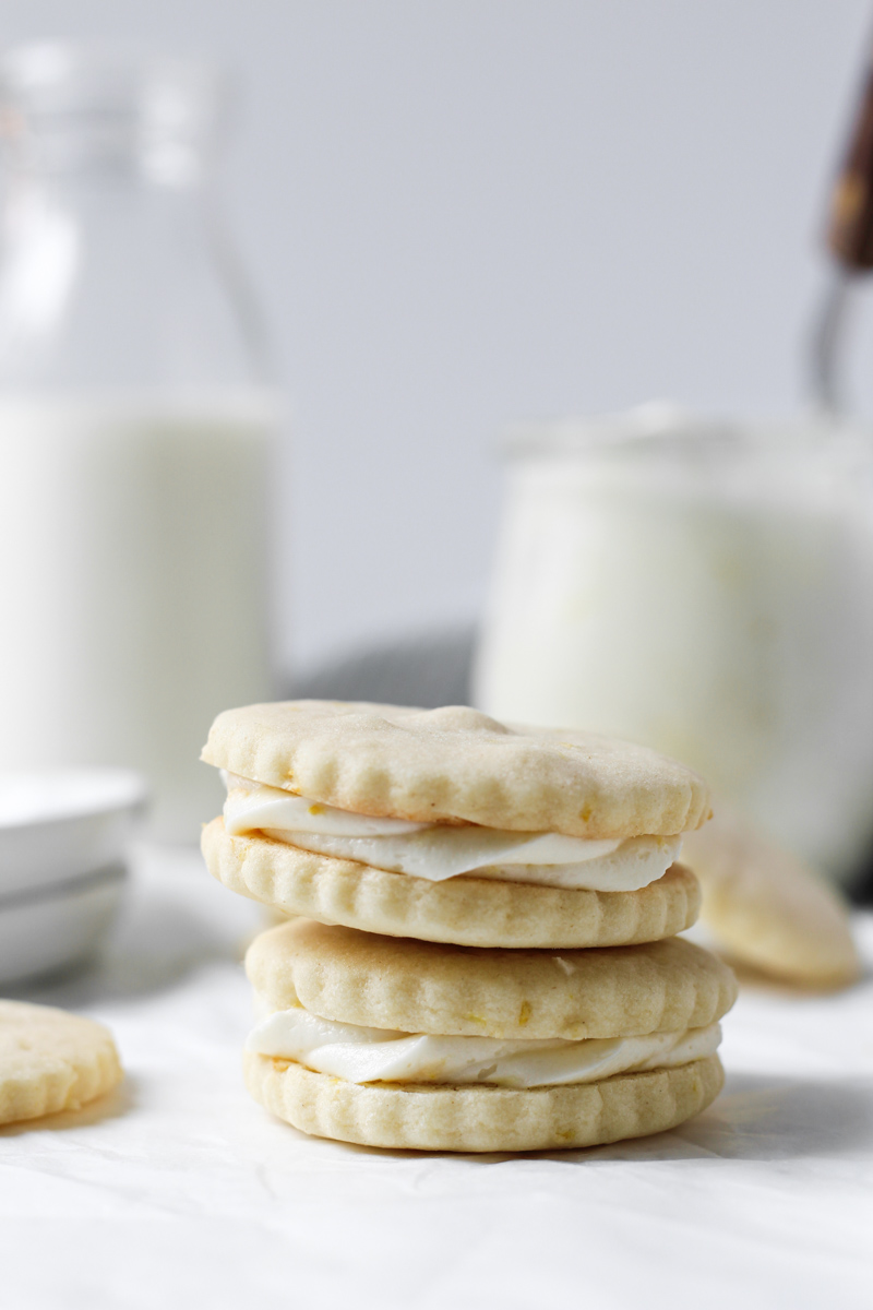 Stack of two lemon butter cookies sandwiched together with lemon buttercream.