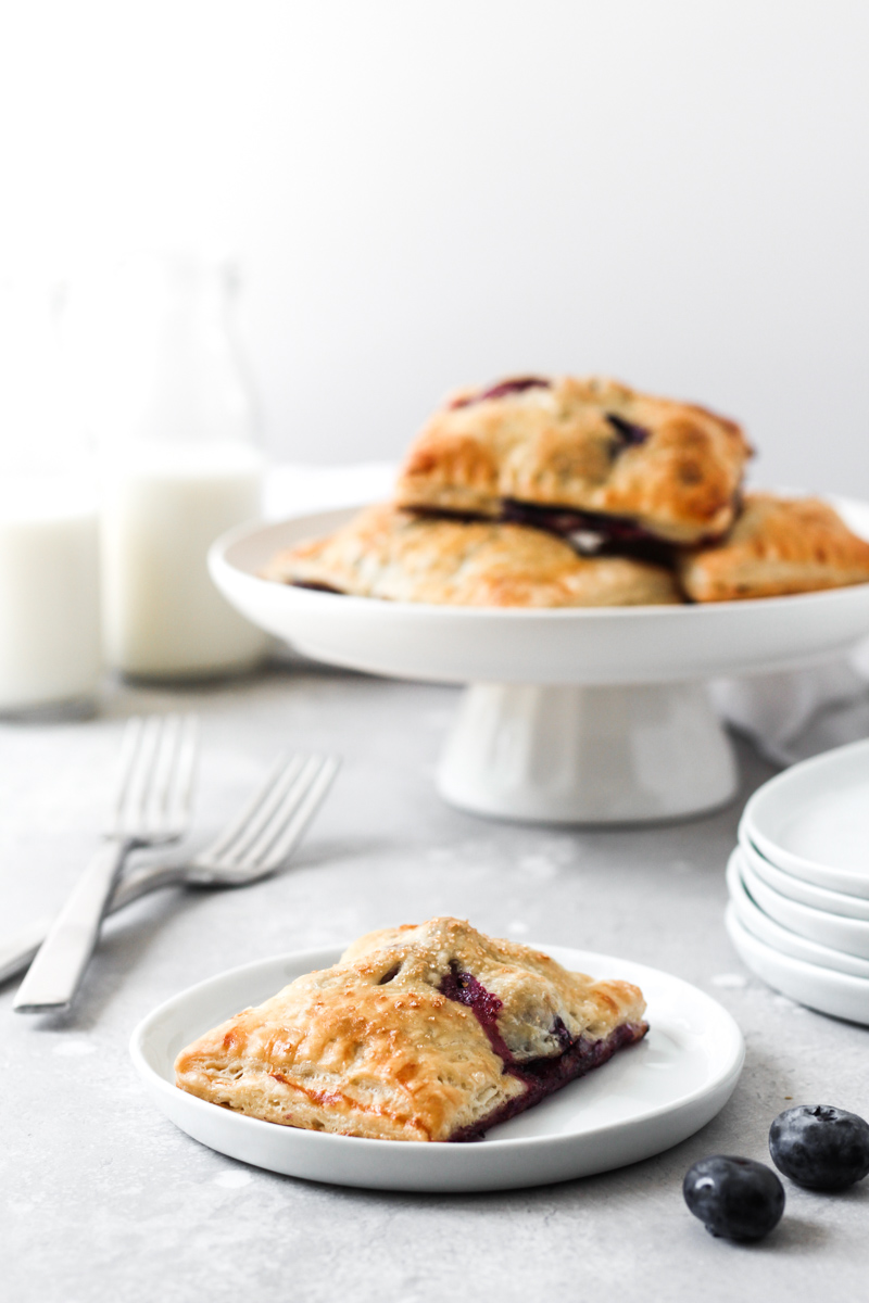 Blueberry Hand Pies on dish and cake stand