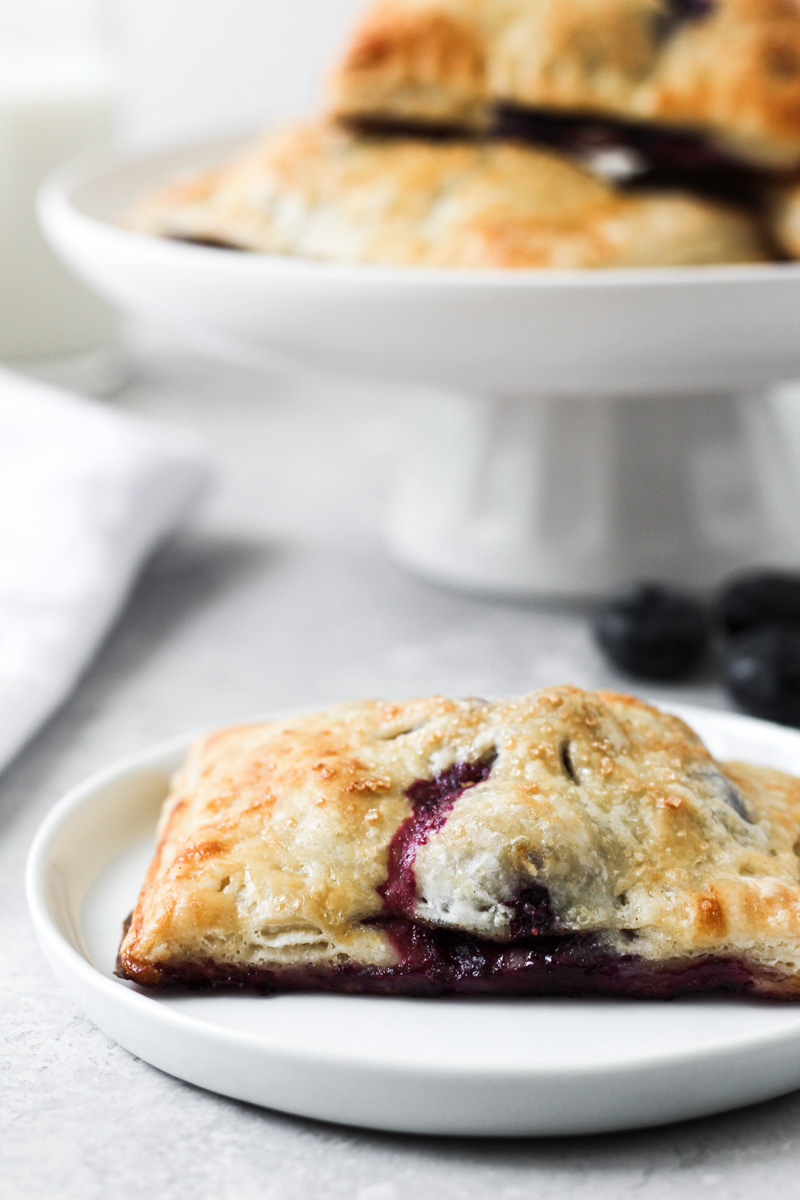 Blueberry Hand Pies on dish and cake stand