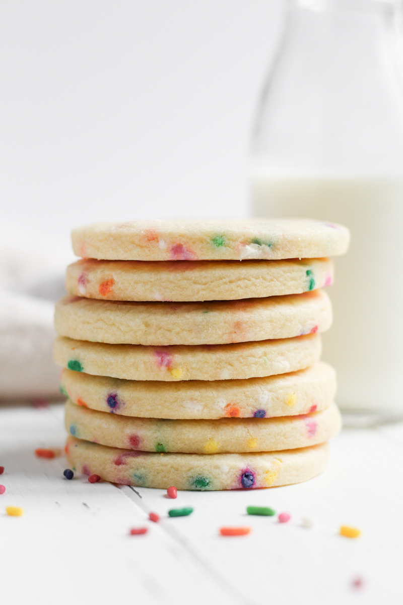 Stack of round funfetti cutout cookies.