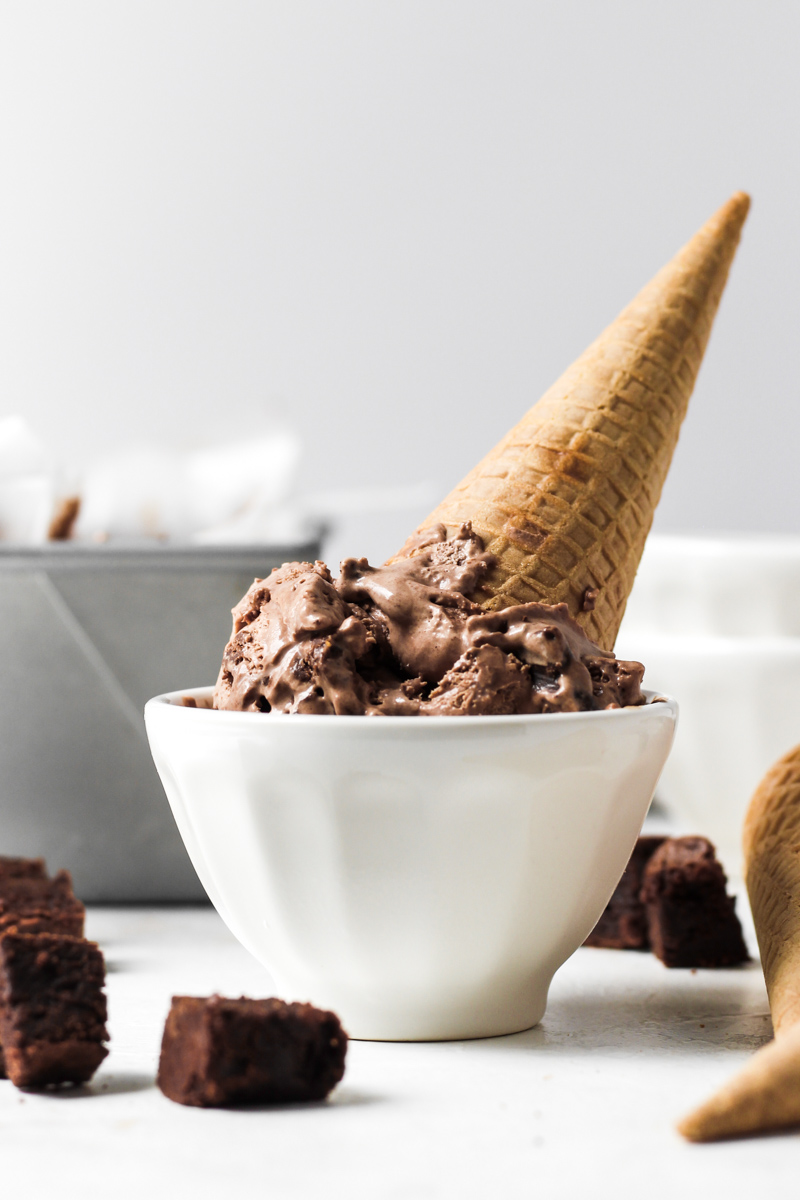 Upside down cone of No Churn Chocolate Brownie Ice Cream in a bowl