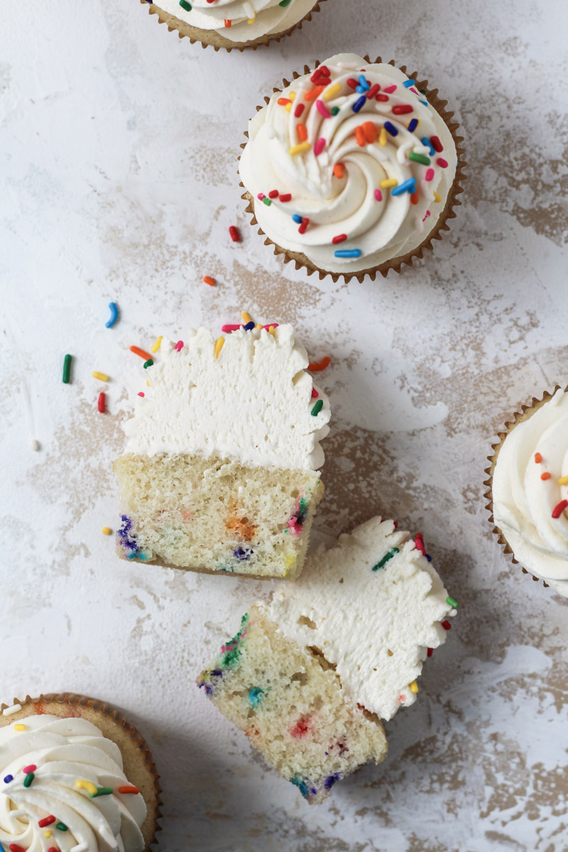 Sliced Funfetti cupcake with vanilla buttercream and rainbow sprinkles