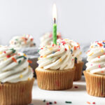 Funfetti cupcakes with vanilla buttercream, rainbow sprinkles, and a birthday candle