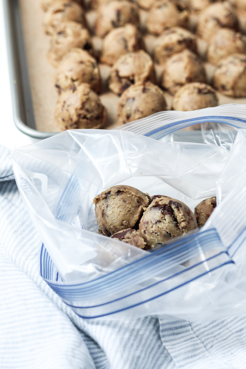 Browned butter chocolate chip cookie dough balls being prepped in a freezer bag for storing in the freezer..