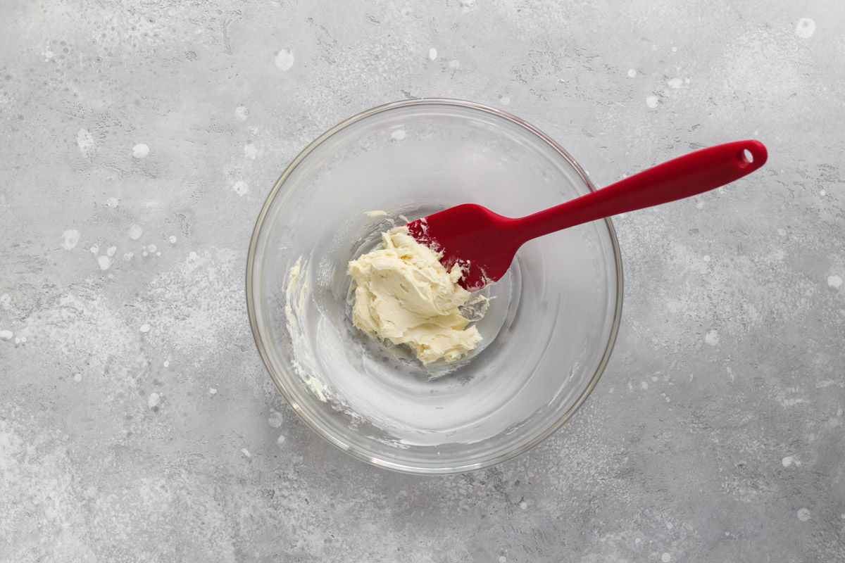 Creamed butter, vanilla and salt in a glass bowl for almond cream.