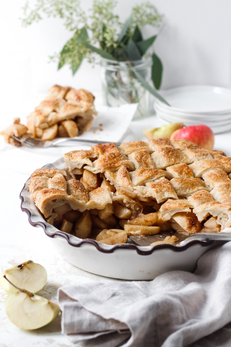 Chai spiced apple pie with three slices removed and one slice in the background.