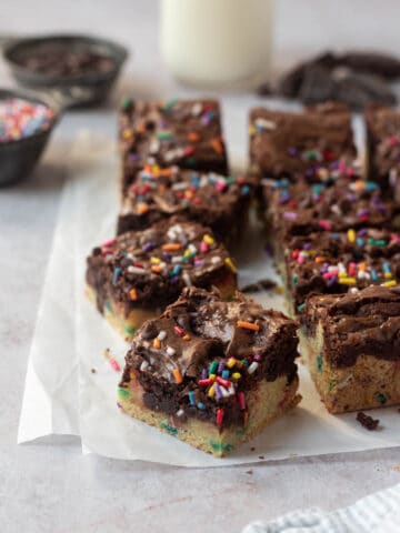 Birthday cake brownies topped with sprinkles and cut into squares.