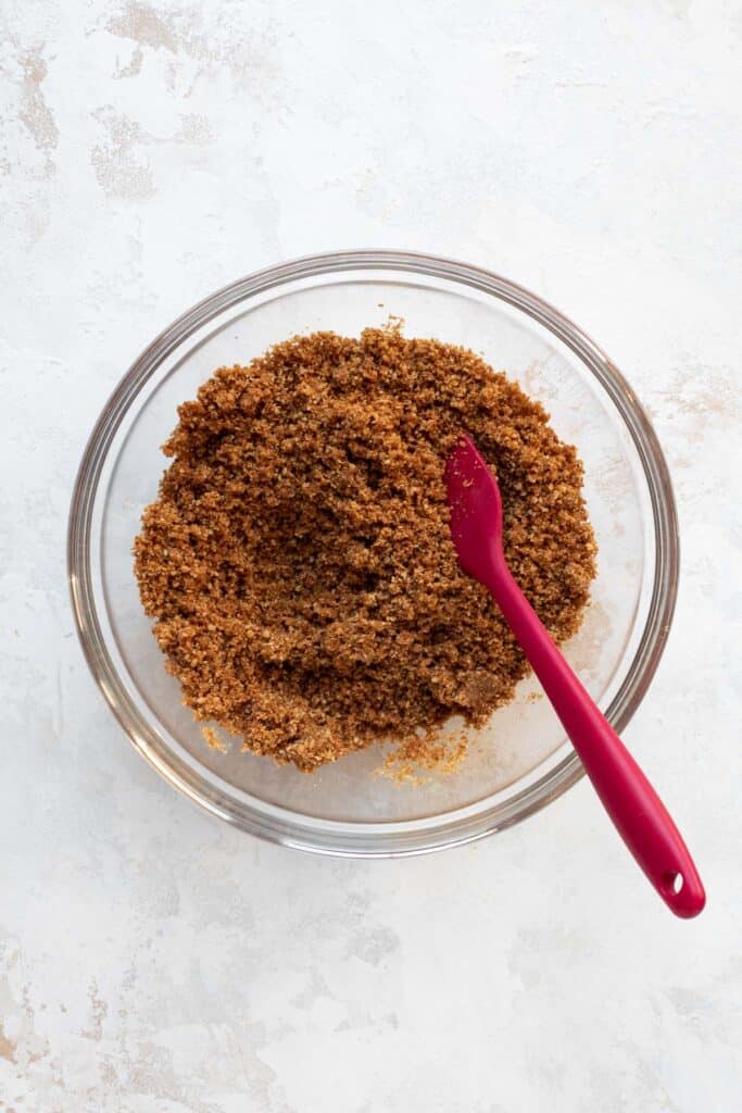 Graham cracker crust ingredients mixed in a bowl.