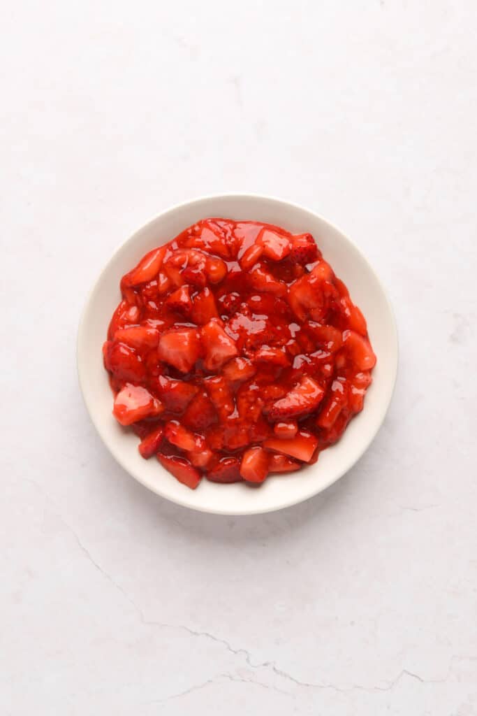 Cooked strawberry filling in a small bowl cooling for strawberry filled cupcakes.