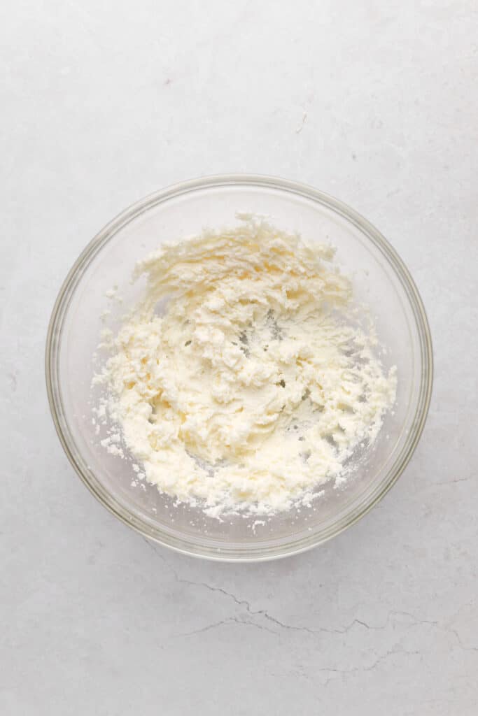 Mixing bowl of creamed butter and sugar for strawberry cupcakes.