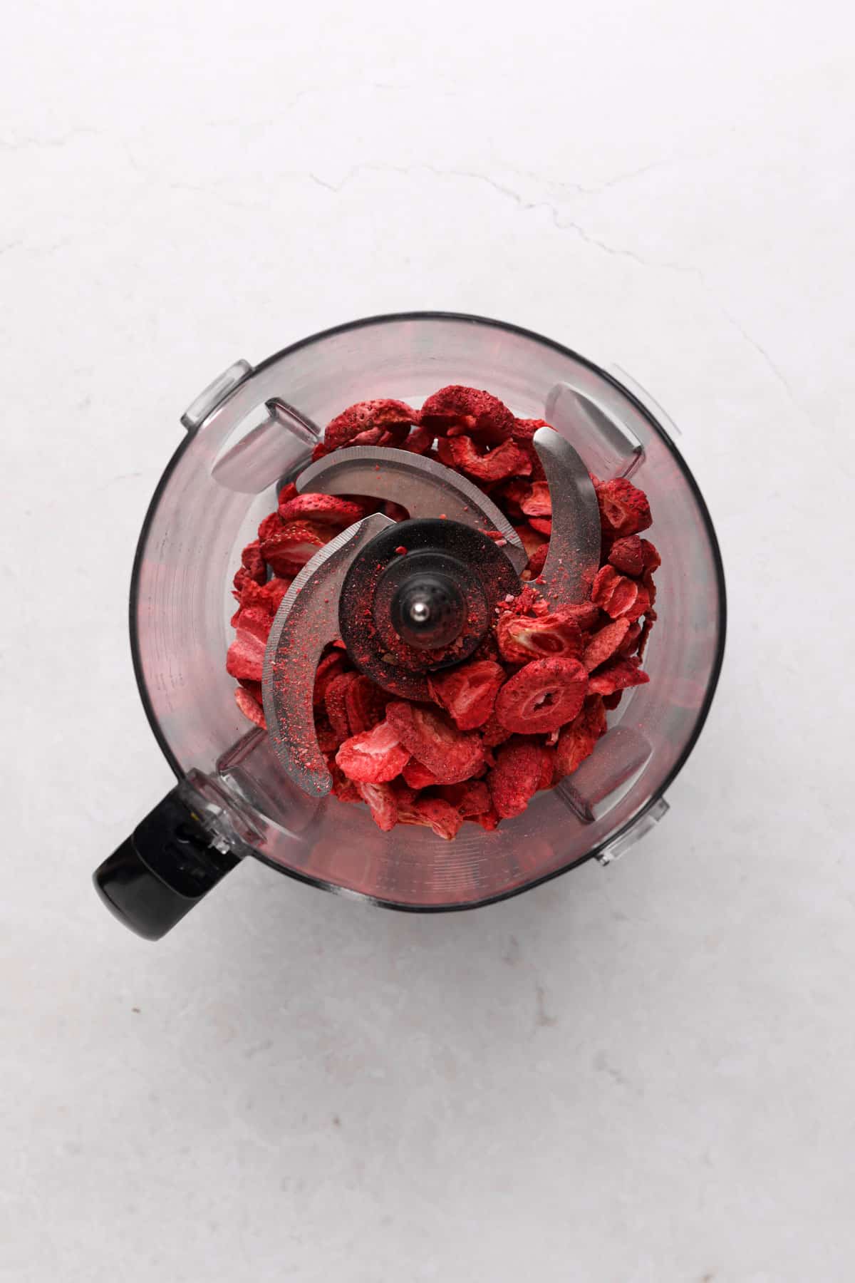 Food processor with freeze dried strawberries.