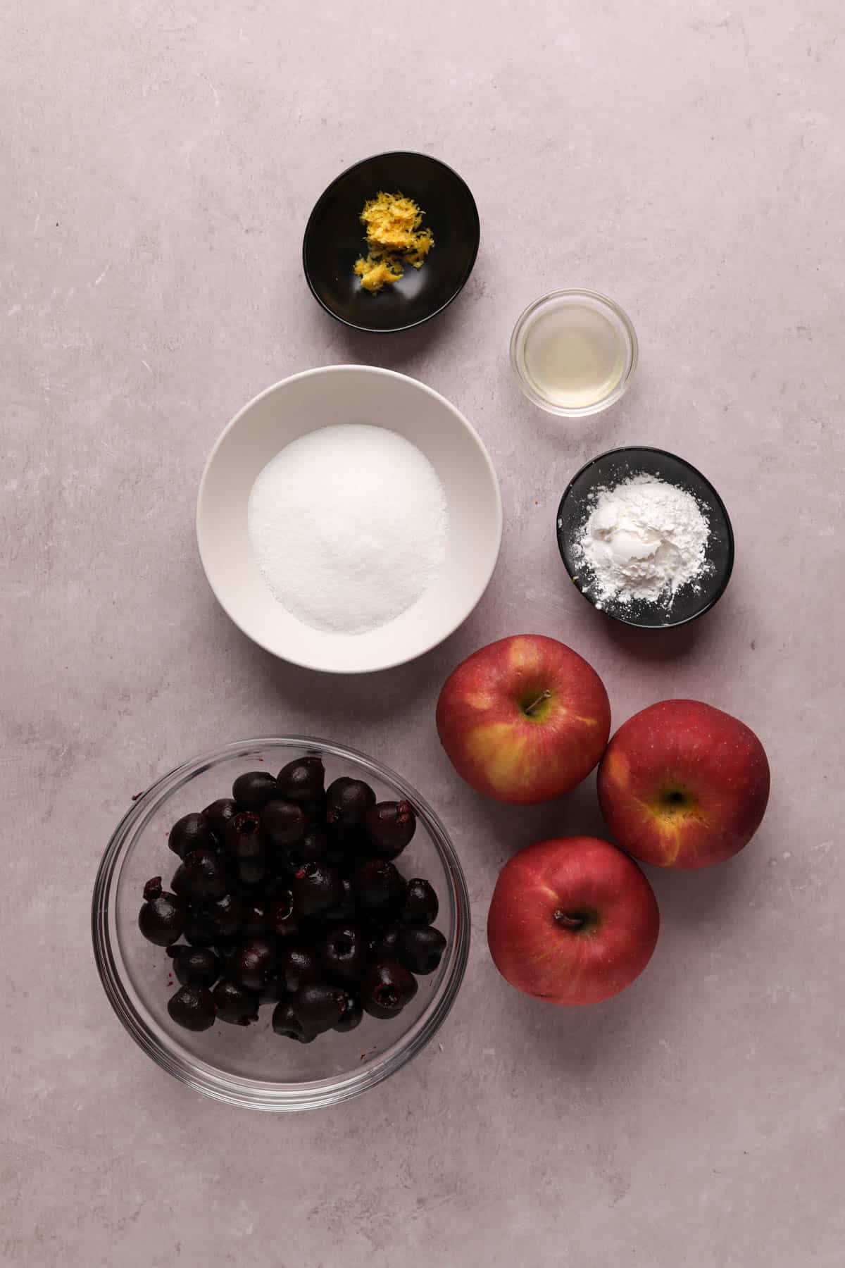 Bowls of ingredients for cherry apple crumble.