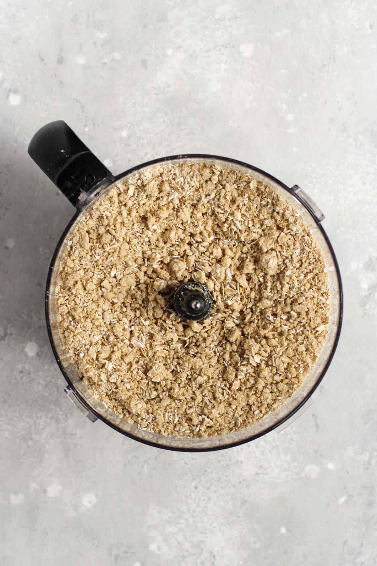 Crust and topping ingredients in a food processor processed with butter into a crumble mixture.