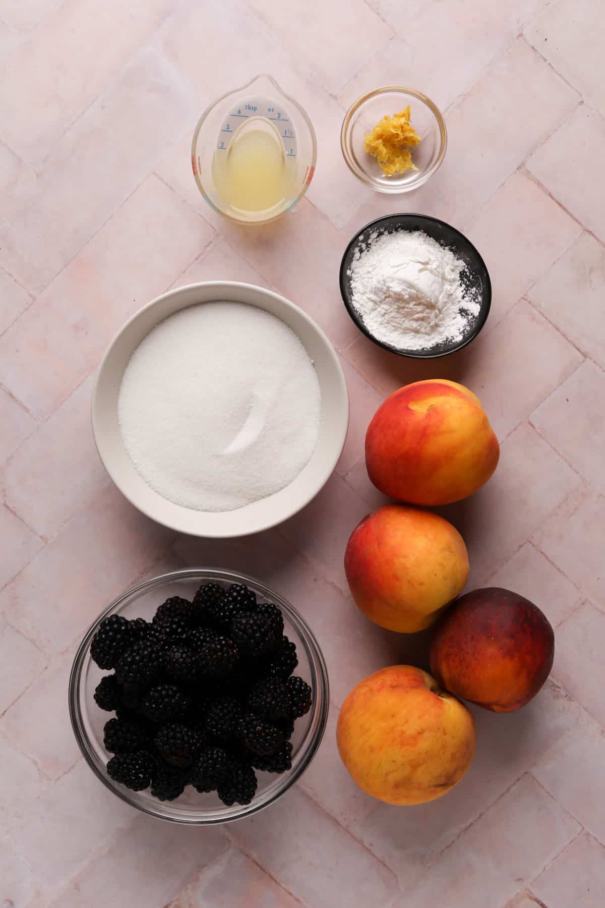 Peach blackberry crisp filling ingredients in bowls.