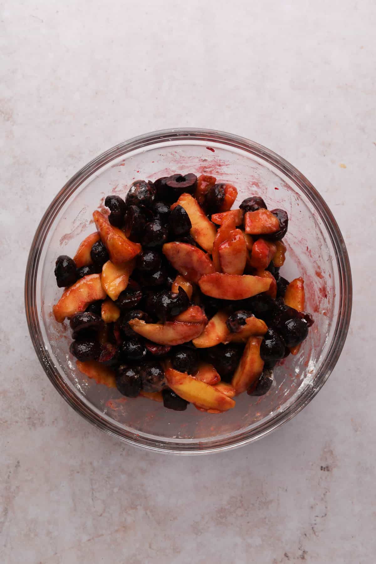 Peach cherry crisp filling mixed in a glass bowl.