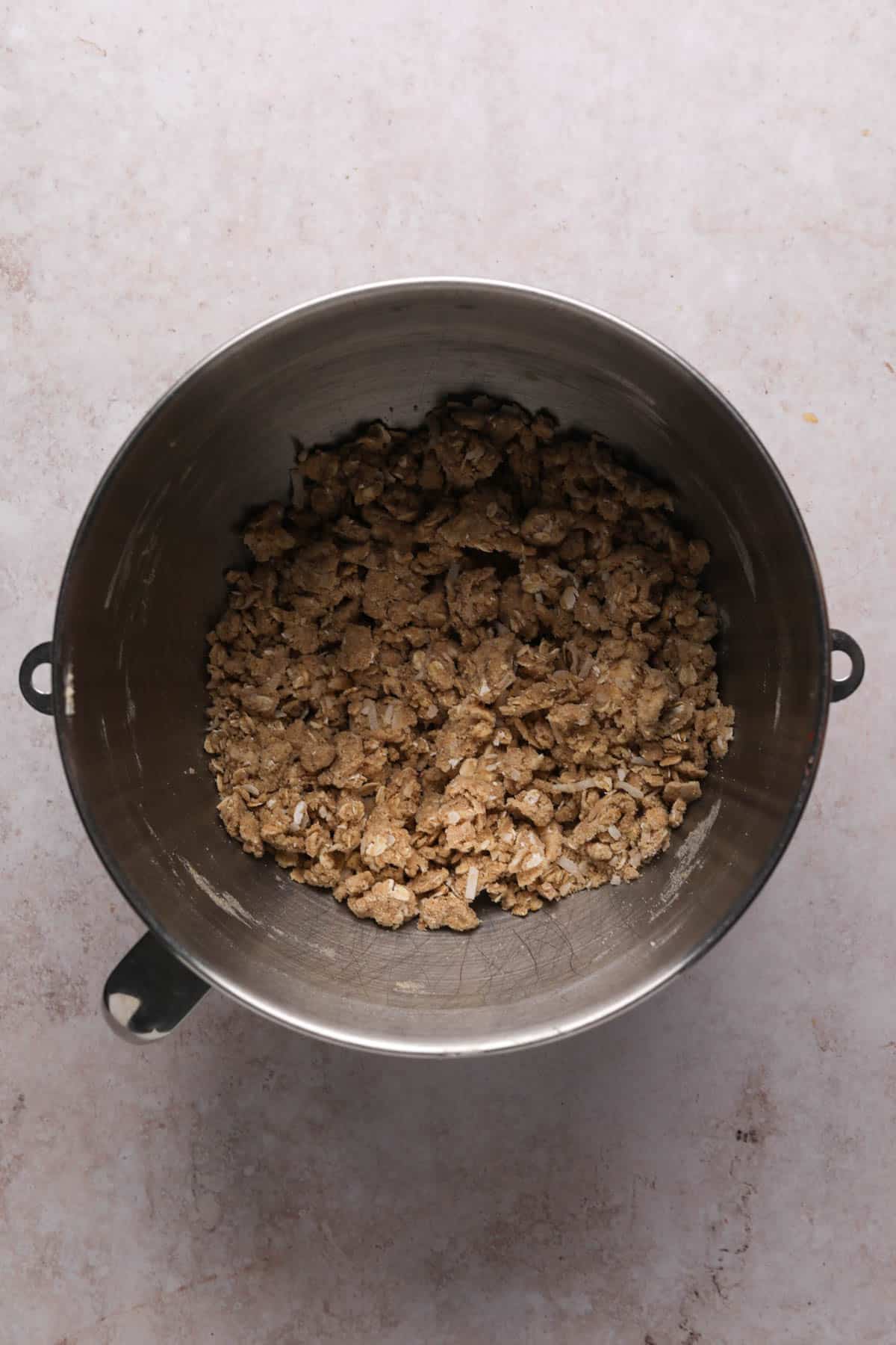 Peach cherry crisp toppings mixed in a stand mixer bowl into a crumble topping.