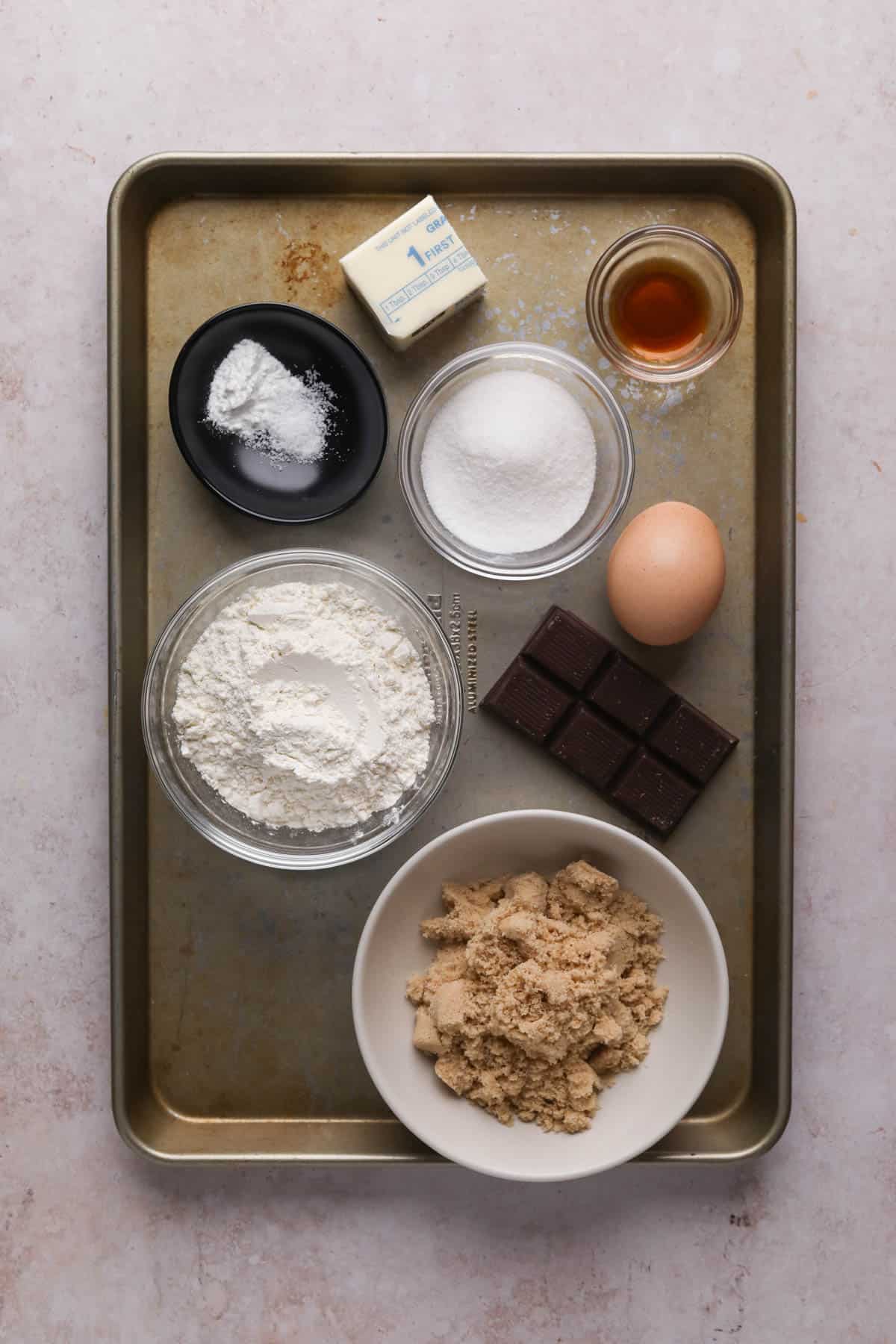 Ingredients for blondie batter in bowls on a sheet pan.