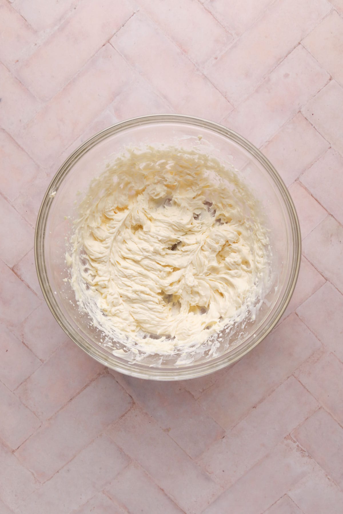 Mascarpone frosting mixed in a glass bowl.