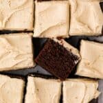 Overhead shot of chocolate coffee cake sliced into squares with one sliced on it's side.