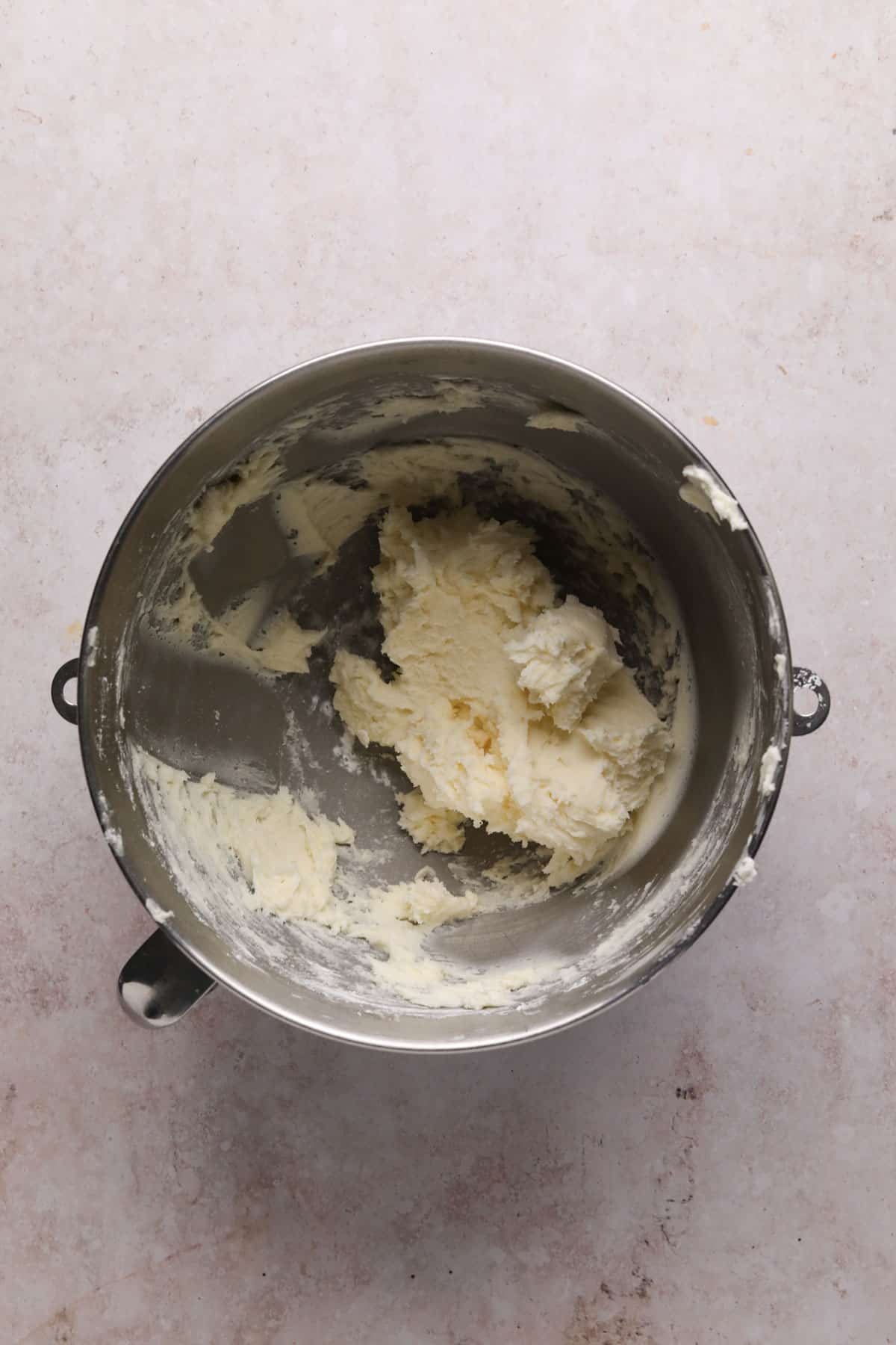 Powdered sugar mixed with the creamed butter in a stand mixer bowl for coffee frosting.