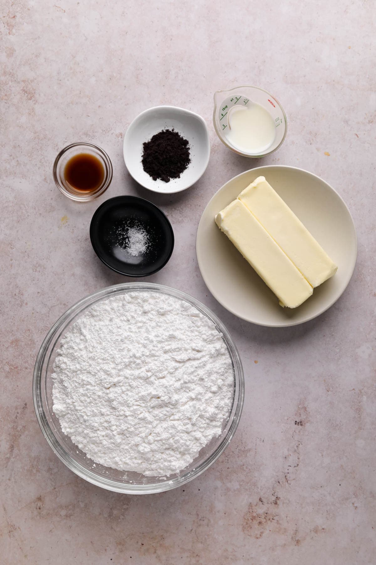 Ingredients for coffee buttercream in bowls on a flat surface.