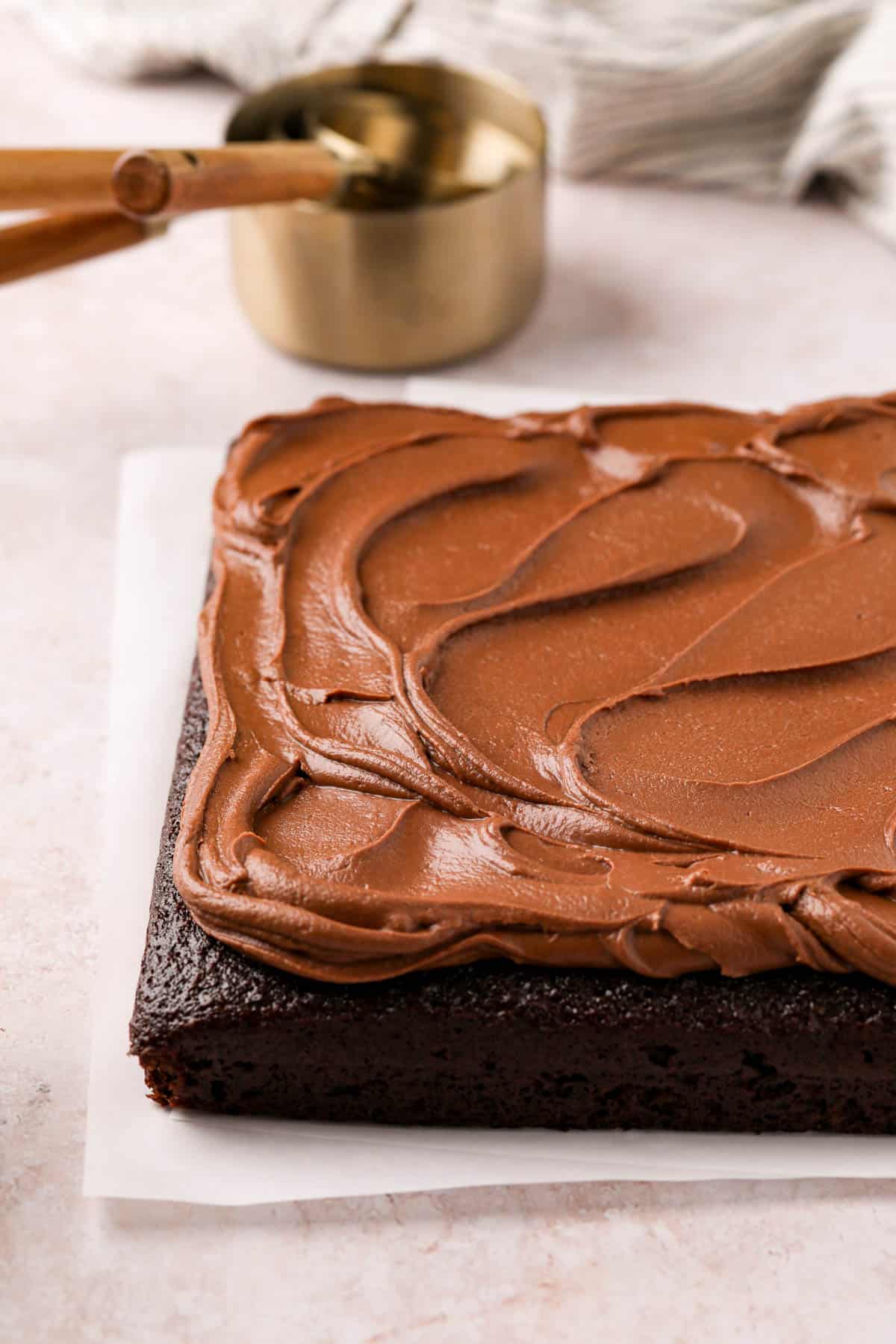 Square chocolate cake topped with silky chocolate fudge frosting.