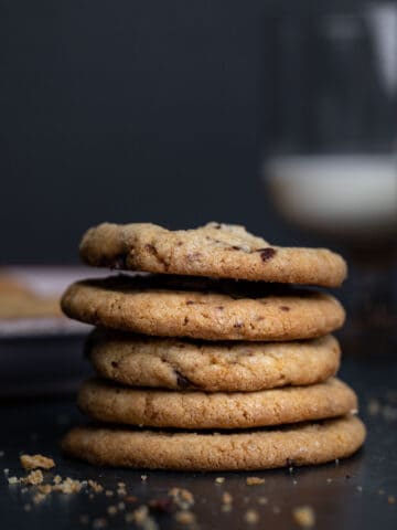 Stack of cookie butter cookies with chopped chocolate.