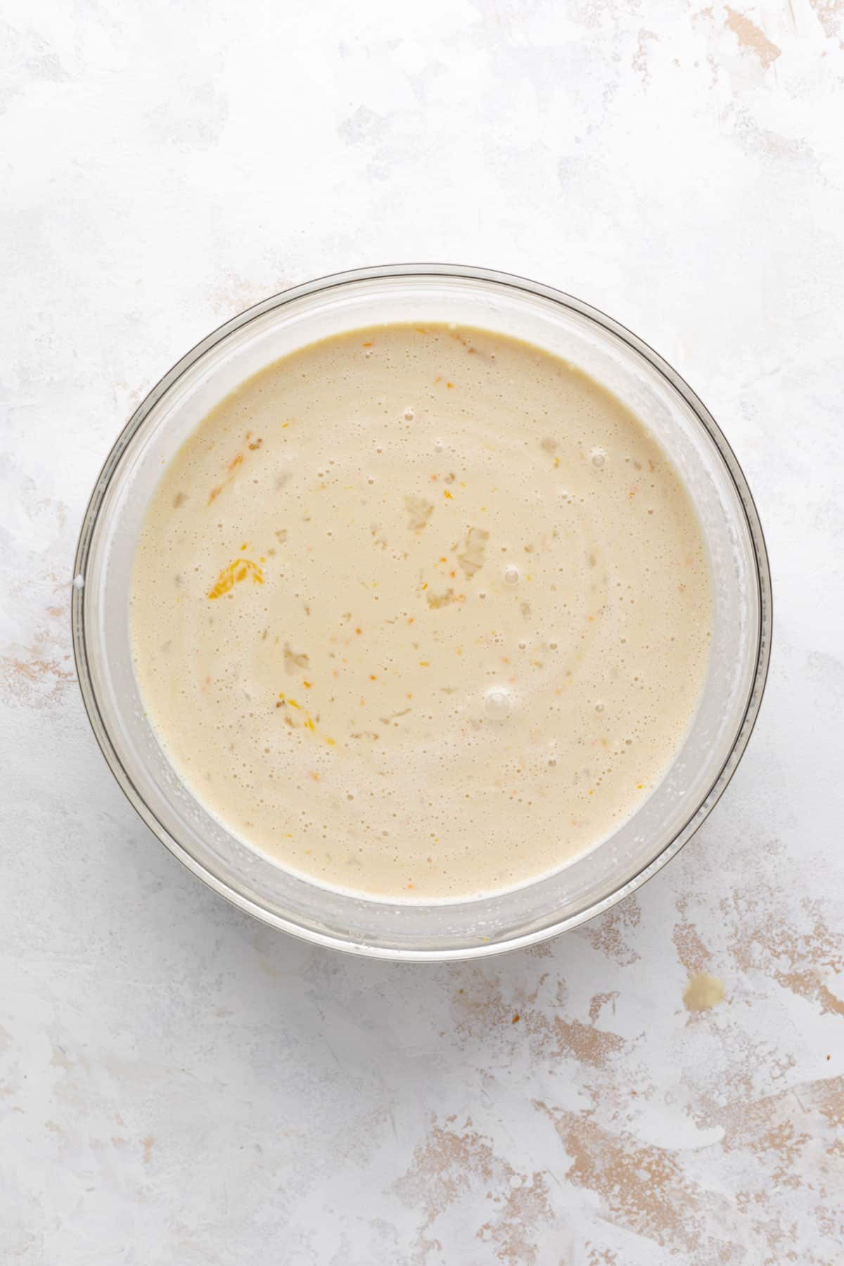 Custard filling for bread pudding mixed in a glass bowl.