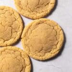 Small batch sugar cookies on a flat white surface.
