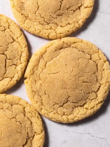 Small batch sugar cookies on a flat white surface.