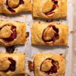 Roasted strawberry hand pies on a parchment lined sheet pan.