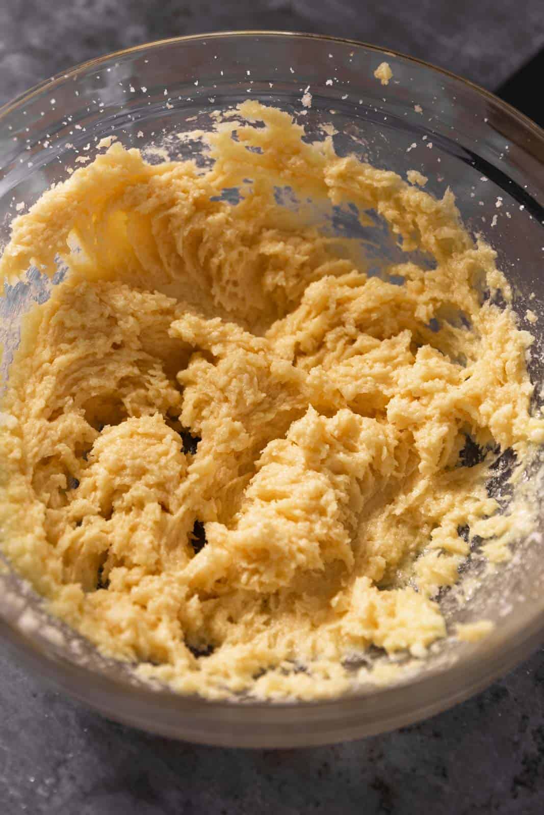 Creamed butter and sugar in a glass mixing bowl.