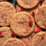 Overhead shot of strawberry sugar cookies layered on cookie rack.