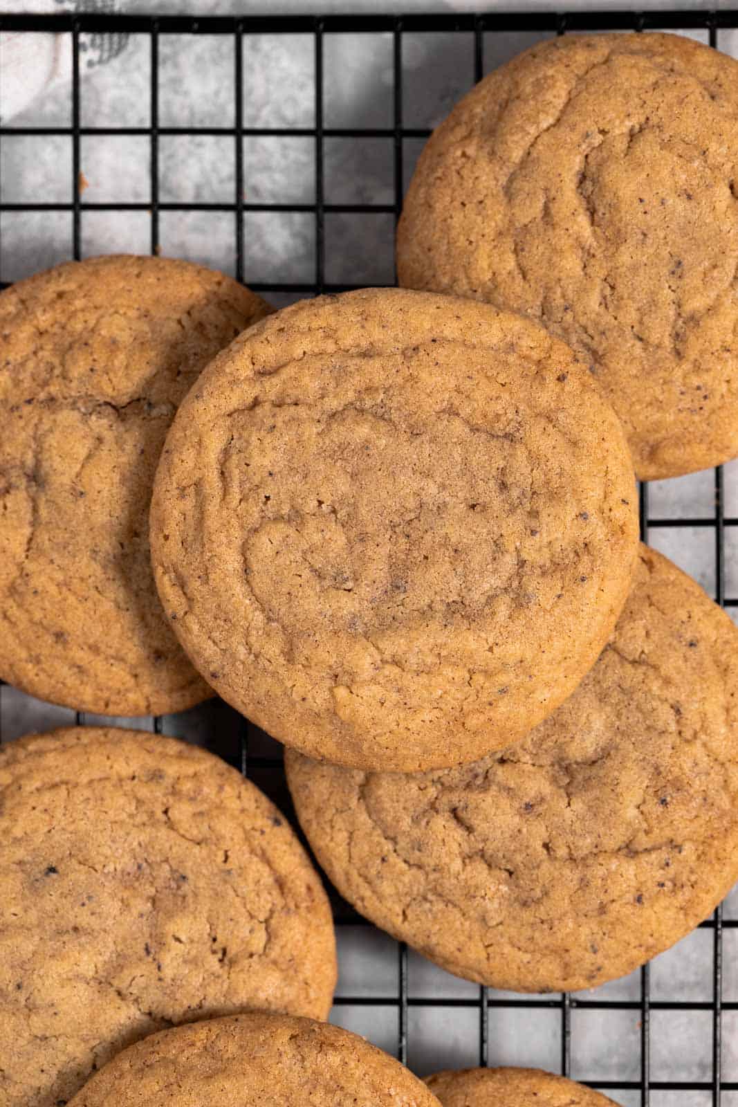 Overhead shot of chocolate chipless cookies on a black cooling rack.